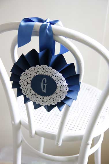 paper rosettes for chair decoration Pretty paper rosettes tied to the back 